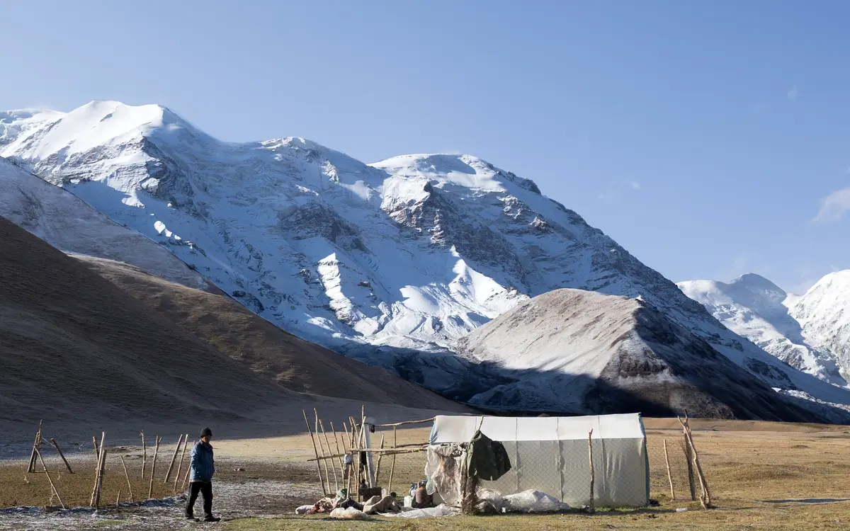 A summer shepherd's tent on the foot of snowy mountains of Tien Shan in Kyrgyzstan