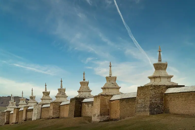 a group of stupas sitting on top of a lush green field