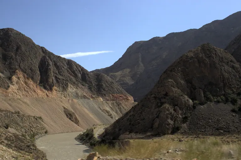 the tumultous and grey river of Naryn, in the canyon down of Kazarman town