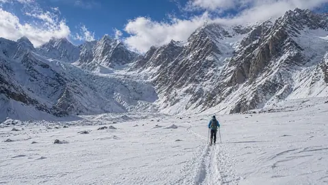 A lone skier making its way down the pristine slopes of Gilgit-Baltistan