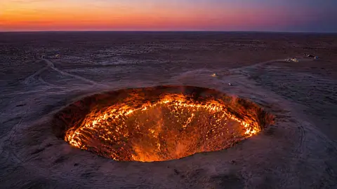 Aerial photography of the Karakum Desert focusing on the Darvaza Gas Crater