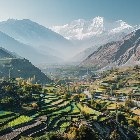  Hunza Valley with terraced fields and snow-capped mountains under a clear sky