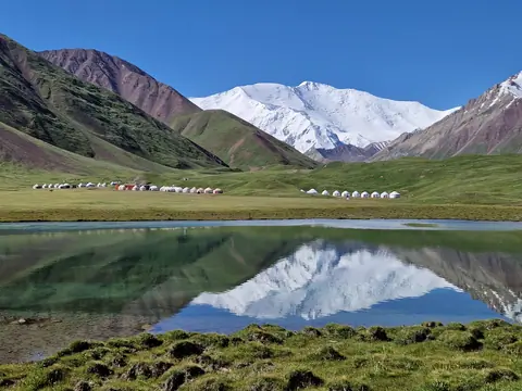Peak Lenin reflecting on the Tulpar Kel lake
