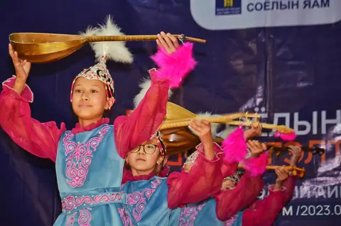 Kazakh girls from Mongolia dancing at the cultural center of Sagsay