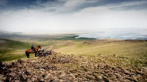 Djigit on horse at Son Kul lake