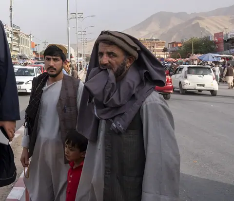 Afghan boy with father and grand father in the main street of Pole e Khomri city in Afghanistan