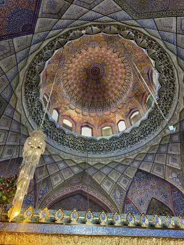 Interior of the coupole of the Blue Mosque, featuring high vaulted ceilings, intricately tiled walls in shades of blue and white, and a large prayer hall carpeted in red, with soft natural light filtering through arched windows.