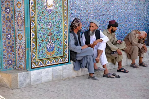 People gathered in the mosque’s open square, surrounded by the mosque’s arched colonnades and gardens