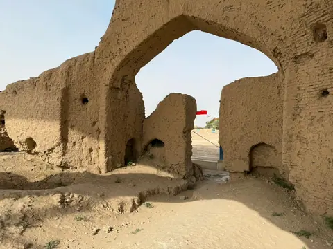 Archaeological remains in Balkh, Afghanistan, traditionally believed to mark the birthplace of the poet Rumi—crumbling mud-brick walls in a dry, historic landscape.
