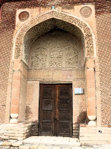 The wooden and carved door of the north mausoleum of Uzgen