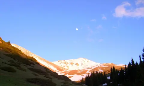 View of the snowy pass of Kalmak Ashuu on the top of fir-tree forest