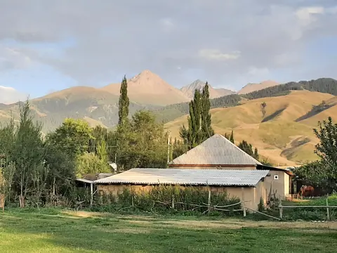 View from the garden of the Lira's guesthouse with green mountains on the background