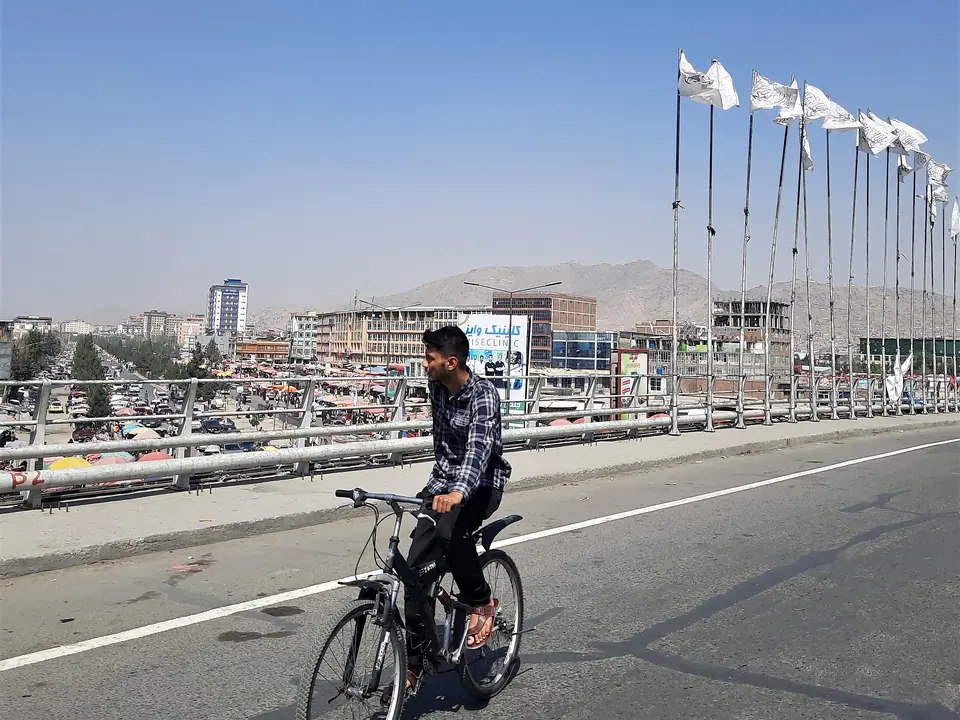 A biker on the bridge in the city center of Kabul
