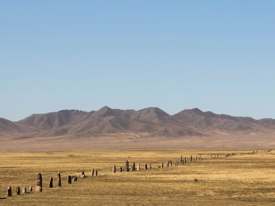 stone poles are standing in the middle of the steppes