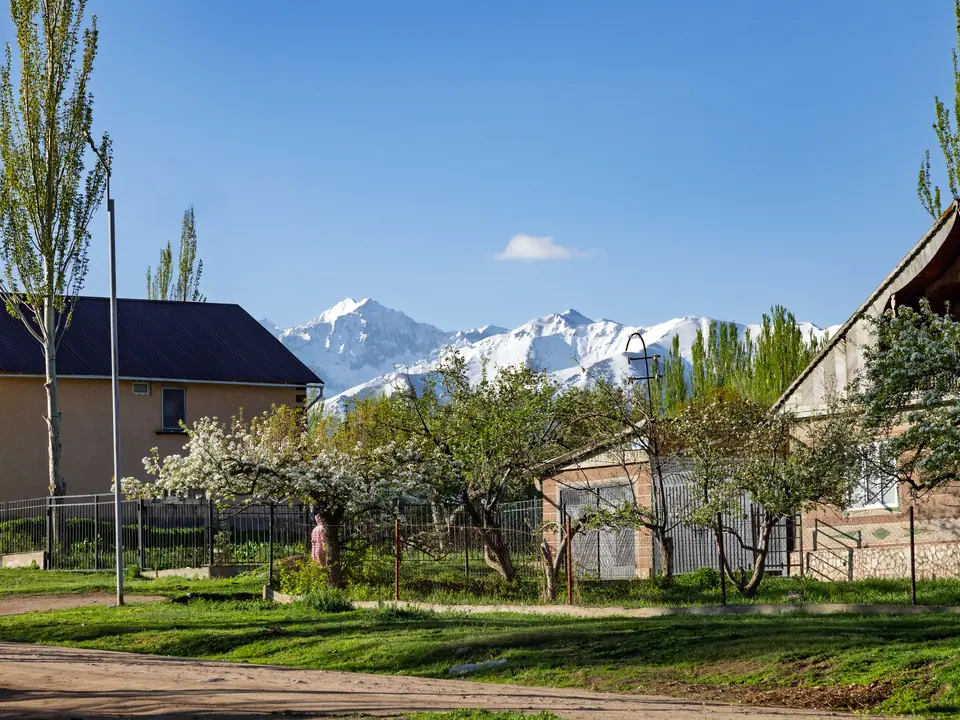 Houses and mountains in Svetlana Polyana in spring