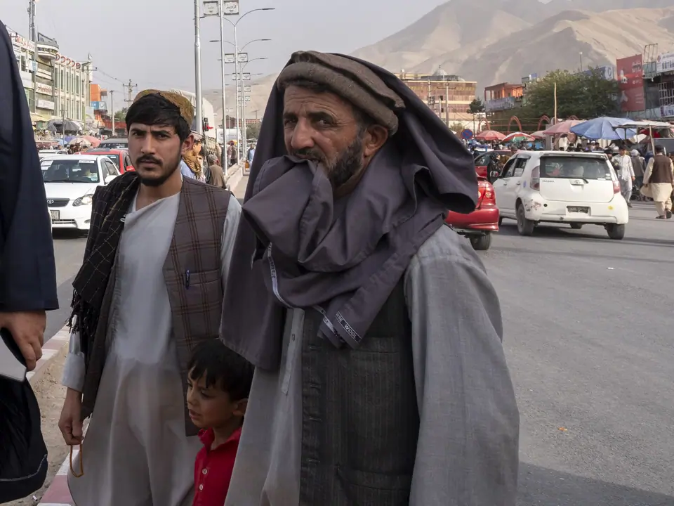 Afghan boy with father and grand father in the main street of Pole e Khomri city in Afghanistan