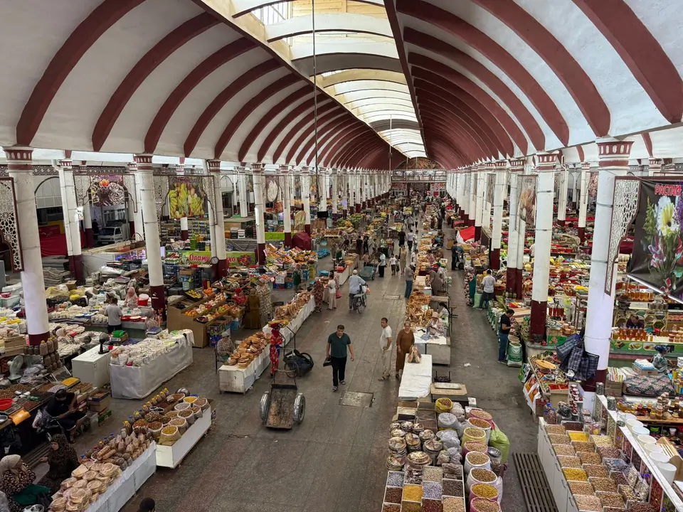 Panjshanbe Bazaar is Khujand’s bustling historic market, one of the oldest in Central Asia, where centuries-old trade traditions meet vibrant daily life in a grand Soviet-era hall beside the city’s main mosque and mausoleum.