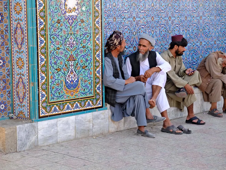 People gathered in the mosque’s open square, surrounded by the mosque’s arched colonnades and gardens