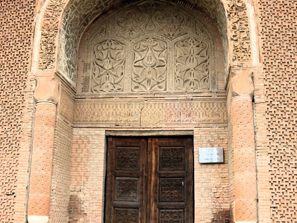 The wooden and carved door of the north mausoleum of Uzgen