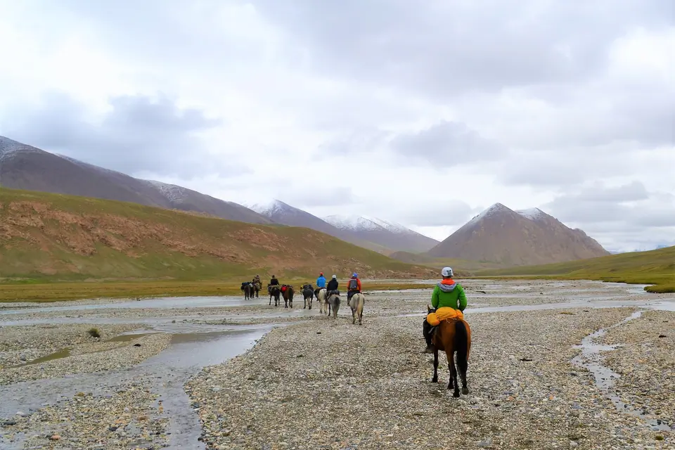 horseback riding on the foot print of the Swiss adventurer Ella Maillart, crossing a river