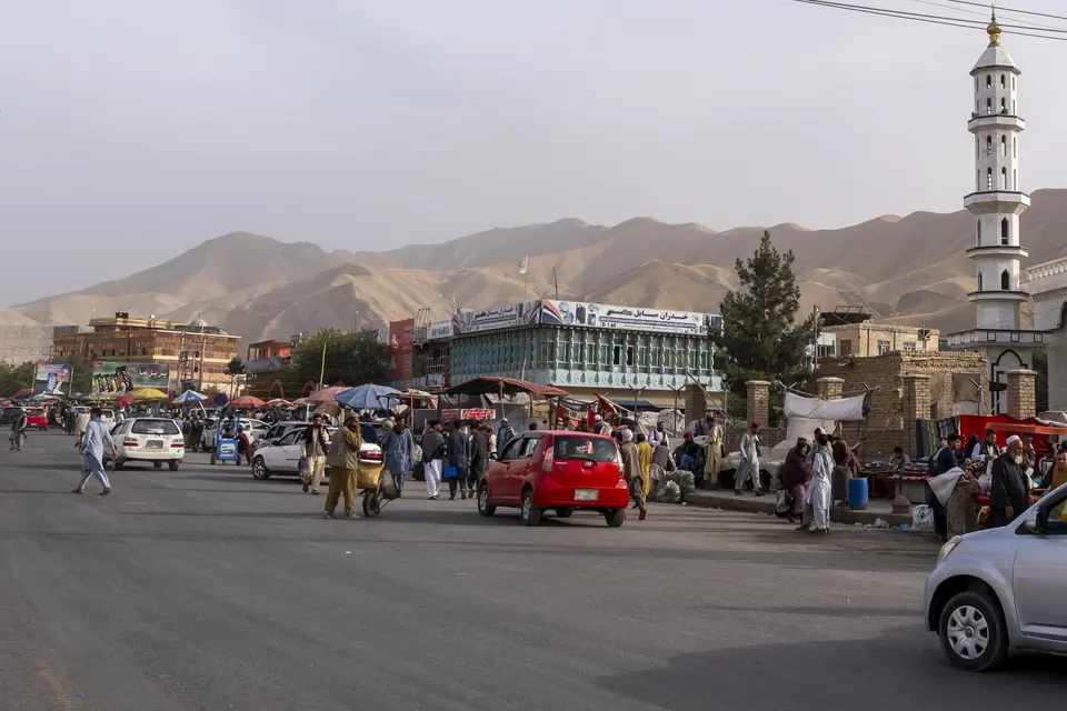 View of the main street of Pol e Khomri at crossroads between Mazar i Sharif, Kunduz and Kabul, we can see the minaret of the mosque and crowd in the street.