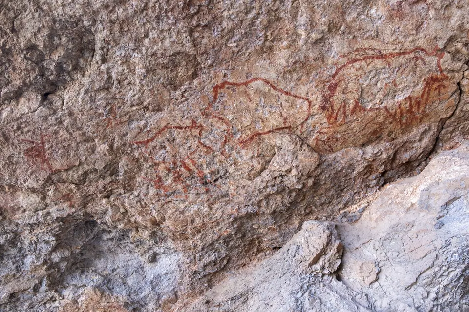 We can see yacks designing with red colors on a rock of the Shakhty cave
